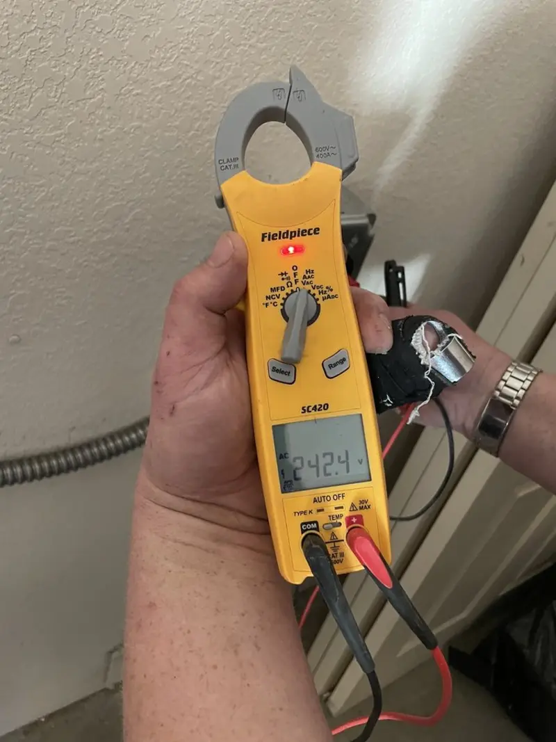 Voltage testing with clamp meter during Recessed Lighting Installation in Austin